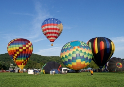 Hot air balloons inflating and rising into the skies over Warren County, New Jersey.