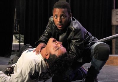 Two males, one holding the other close to the ground