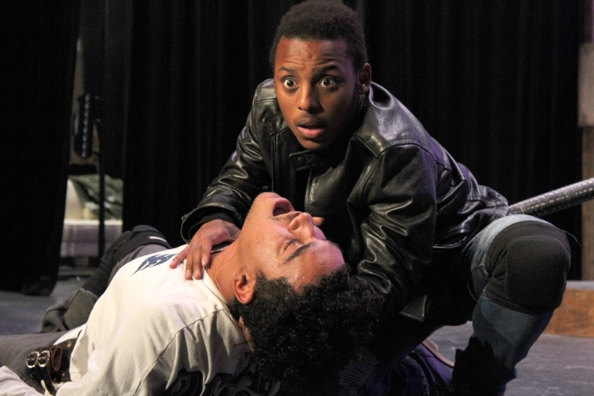 Two males, one holding the other close to the ground